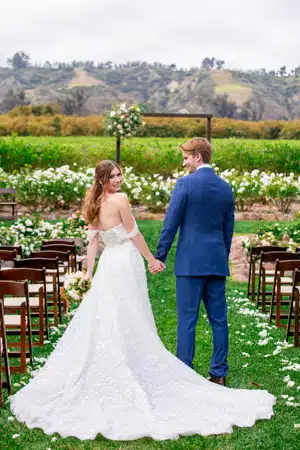 Bride and groom have a cute photo with the wedding venue