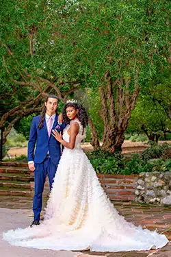 Vibrant wedding couple posing in a lush, natural-light garden.
