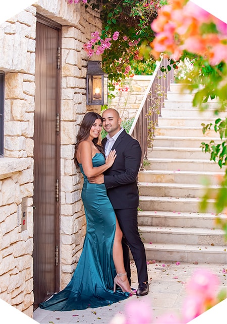 Engagement photography: Couple posing by stone stairs.