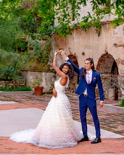 wedding shots: Couple twirling at historic venue.