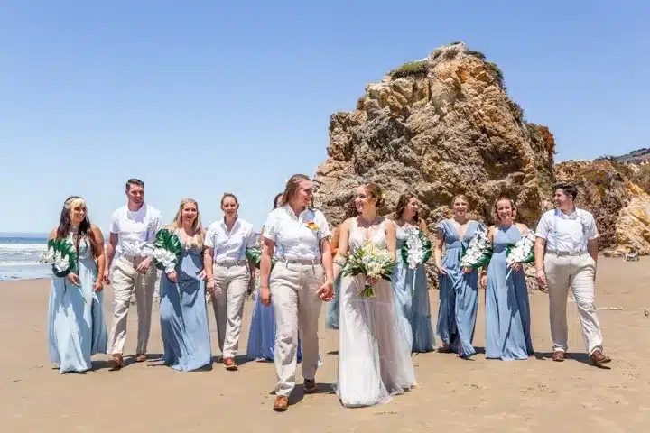 Beach wedding party walking together