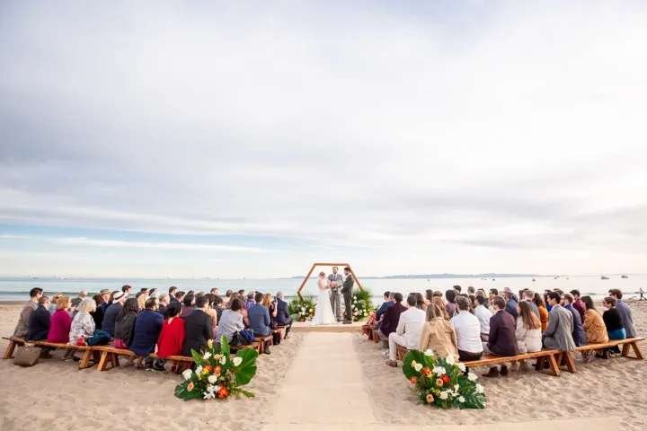 Beach wedding ceremony with guests