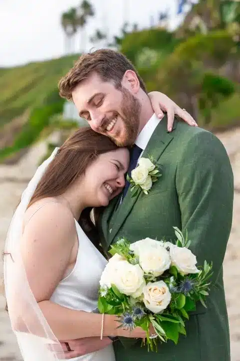 A couple in a romantic pose with a white flower bouquet.