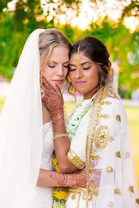 Bride and bride in traditional wedding attire.