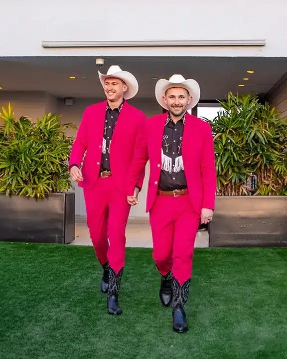 Two men hold their hands.