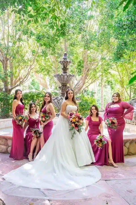 The bride and her friends hold flowers in the garden-3.