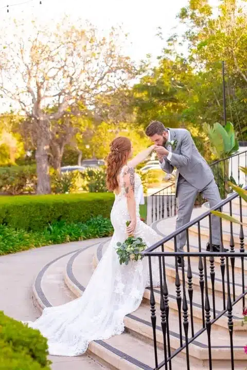 Groom kissing the hand of bride as a sweet gesture before taking her to the stage