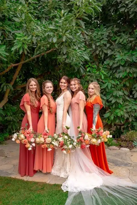 bride with her friends enjoying photoshoot in garden